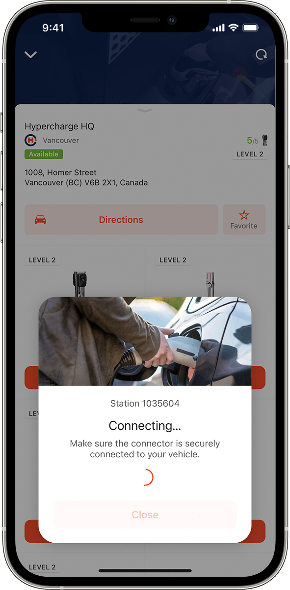 A smartphone screen shows an EV charging app connecting to a station. The pop-up says, “Connecting… Make sure the connector is securely connected to your vehicle,” with an image of a person plugging in an EV charger.
